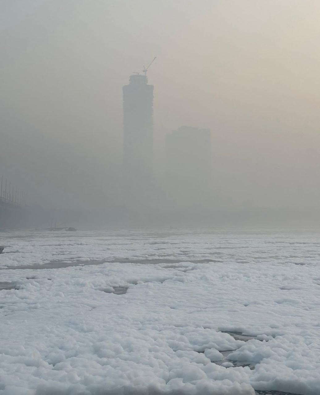 foggy skyline over a frothing river